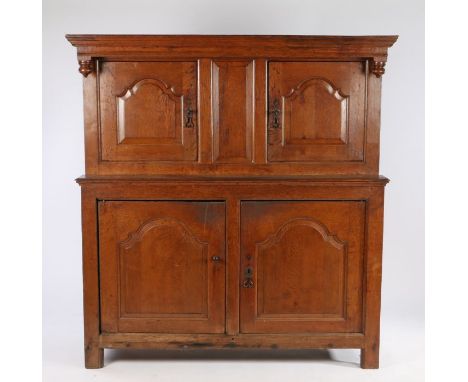 18th Century oak court cupboard, the rectangular top above drop finials and a pair of fielded arched panel doors, the base se