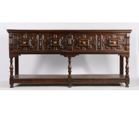 Charles II style oak dresser base, the rectangular top above a pair of geometric drawers above turned legs and oak panel pot 