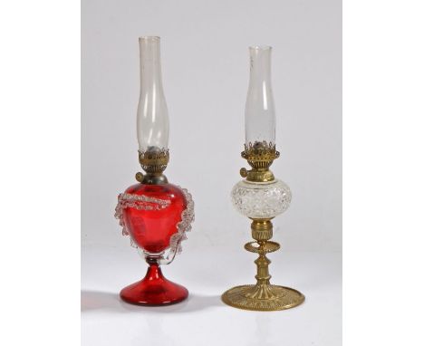 Hinks oil lamp, the clear glass chimney above a ruby glass reservoir with overlaid white glass stylised fern leaf decoration,