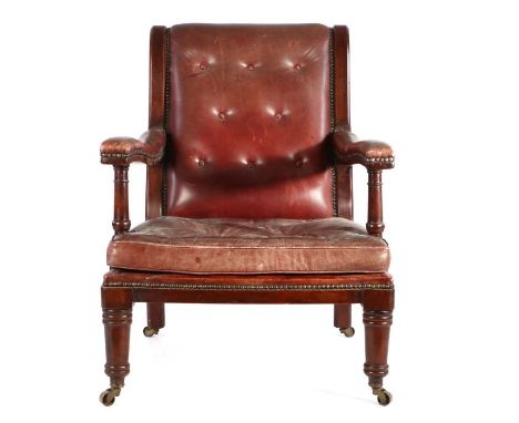 William IV mahogany and leather upholstered library armchair, the arched button back above a leather cushion flanked by long 