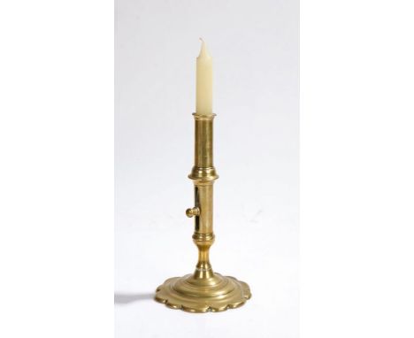 18th Century brass ejector candlestick, English, with a collared nozzle above the push up ejector on a petal base, 19.5cm hig