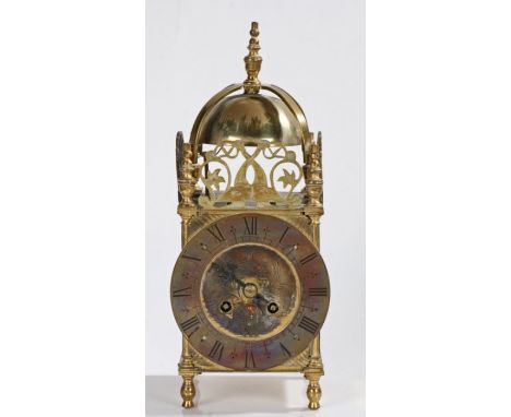 17th Century style brass lantern Clock, the final top above a bell and dolphin fret mounts, the brass chapter ring with Roman