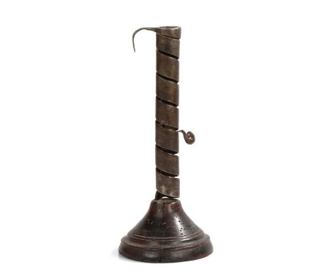 18th Century candlestick, the spiral iron holder above a turned fruitwood stand