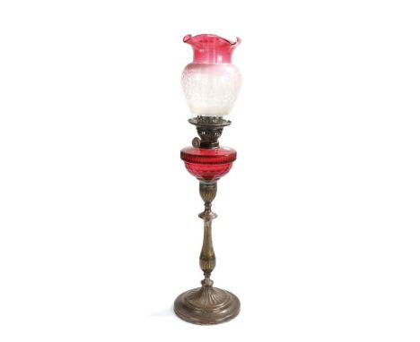 Richard Evered &amp; Sons oil lamp, with clear glass chimney, the flared ruby and clear glass shade with etched scroll decora