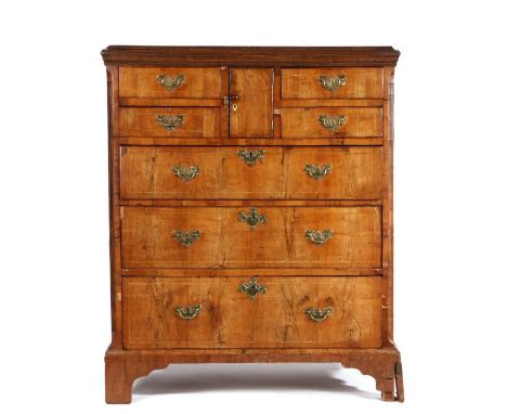 18th Century walnut and oak "Norfolk" chest of drawers, the rectangular oak top above a central cupboard door flanked by two 