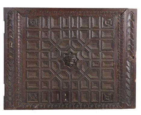 17th Century Dutch oak geometric door panel, with a carved head of a young boy to the centre and a surround of geometric sect