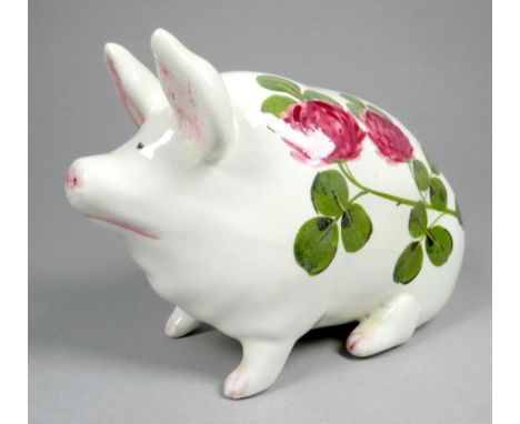 A Wemyss ware pottery pig - decorated with clover flowers, 17cm wide