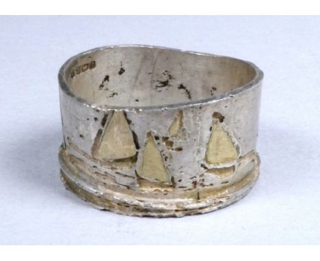 A silver ring, Birmingham, Jennie Hancox of Zennor, engraved with a continuous design of siling boats with gilded sails, size