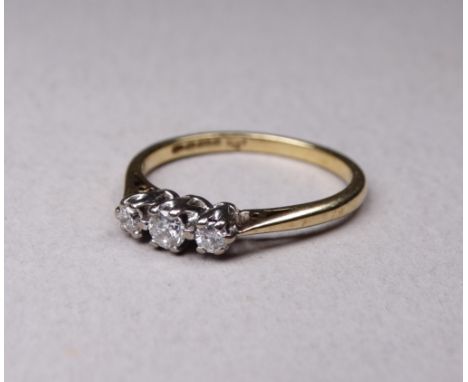 A 9ct three stone diamond ring - size L, 2g