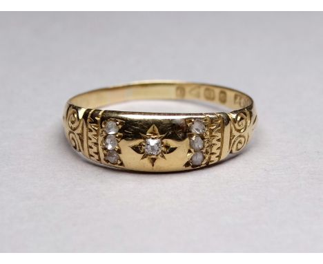 An 18ct gold and diamond set ring - gypsy setting in a foliate band size T, 2.7g