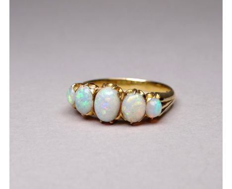 A yellow metal five stone opal ring - the cabochon graduated stones claw set, size N/O, weight 4.4g.