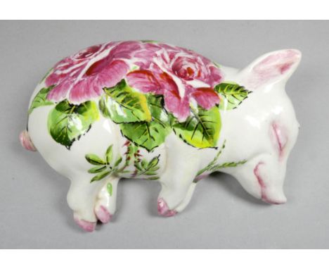 A Wemyss Exon recumbent pottery pig - decorated with cabbage roses by B Adams, impressed and painted marks, length 17cm