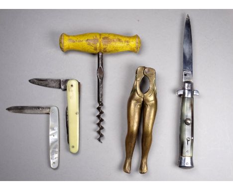 A pair of late 19th century brass nut crackers - modelled in the form of legs, together with three penknives and a corkscrew.