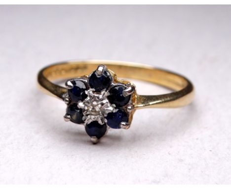 A 9ct sapphire and diamond ring - floral set with a diamond to centre, 2g, size P