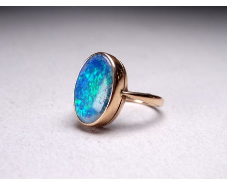 A 9ct gold opal doublet ring - with an oval polished stone, size N, 5.1g