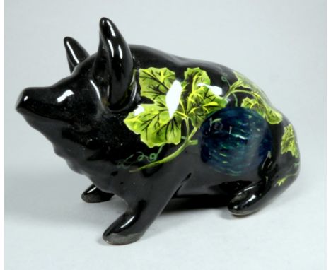 Wemyss Griselda Hill pottery pig - seated, black and decorated with grape and vine, 18cm wide