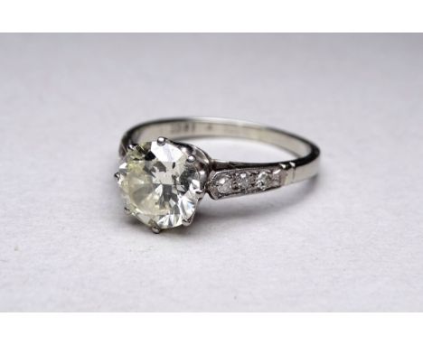 An 18ct white gold solitaire diamond ring - the claw set central stone 2ct approximately within diamond set shoulders, size M