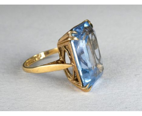 A 9ct gold topaz dress ring - the emerald cut stone within an open claw setting, size K, 6g