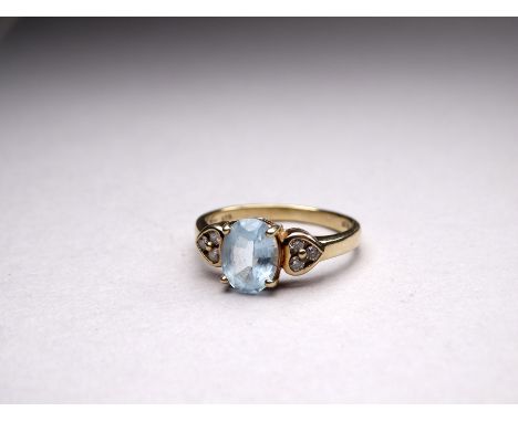 A 9ct gold aquamarine and diamond ring - the oval central stone flanked by diamond heart shaped shoulders, size K, weight 2.1