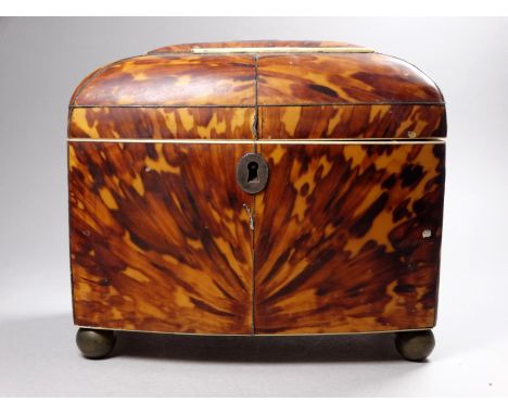 A late George III blond tortoiseshell tea caddy - of bowed rectangular form, with white metal stringing and fittings, the int