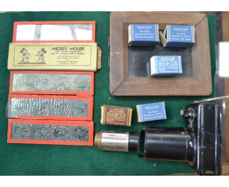 A Mickey Mouse magic lantern by Ensign Ltd, London with various slides and five rolls of stereoscopic pictures by Novelview.