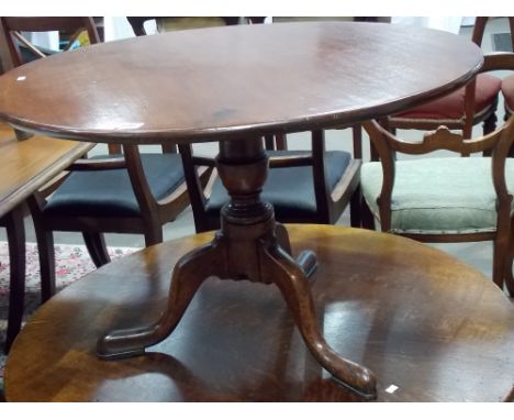 George III mahogany tripod table, the circular top over the shortened baluster turned pedestal with three outswept feet, diam