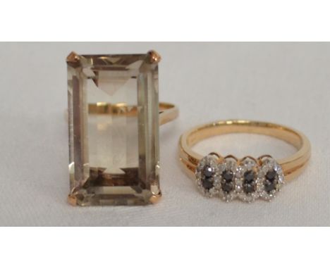 Two 9ct gold dress rings one with a large smoky quartz the other diamond and sapphire set.