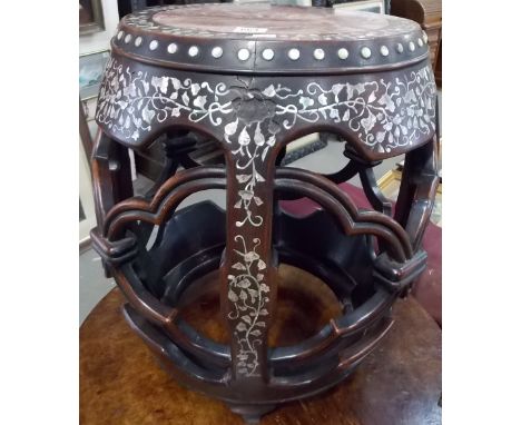 19th Century Chinese hardwood garden seat with mother of pearl inlay, the top with a pink marble inset, the base with trellis