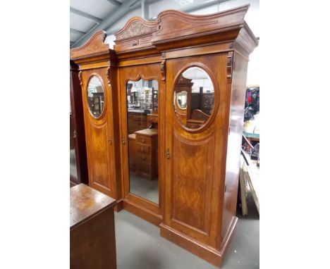 Good Victorian walnut inverted break front triple wardrobe, the moulded cornice over the central mirrored door and three grad