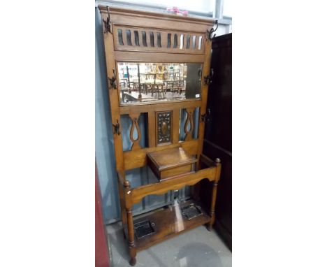 Victorian oak mirror back hall stand, the rectangular bevel edge mirror over an embossed copper rectangular panel and a hinge