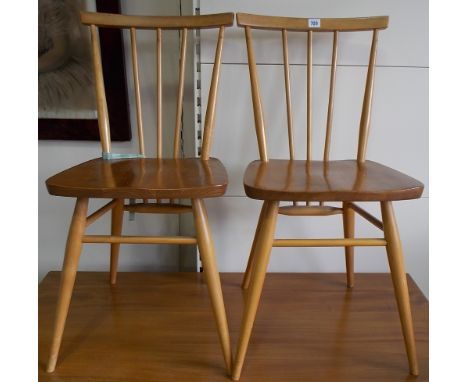 Pair of Ercol pale ash and elm dining chairs with comb back.