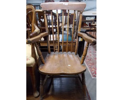 Victorian ash and elm kitchen armchair with a comb back and on ring turned legs with stretchers.