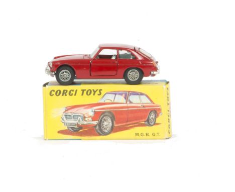 A Corgi Toys 327 M.G.B GT, dark red body, light blue interior, spoked wheels, black suitcase, in original box, E, box G 