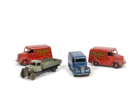 Dinky Toys 31d Trojan 'Oxo' Van, 31b Trojan 'Dunlop' Van (2), one maroon hubs, one red hubs, early post-war 25e Tipping Wagon