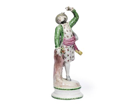 A Volkstedt porcelain figure of a manCirca 1775The figure standing in a dancing pose, wearing a green jacket and a pink sash,