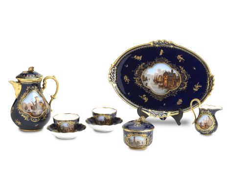 A Meissen style tête-à-têteCirca 1900Painted with merchant quayside scenes within gilt quatrilobed panels, on a deep blue gro