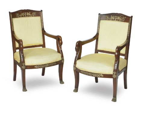 A pair of mahogany Empire Revival open armchairs, early 20th centuryThe curved crests to top inset with ormolu mounts of wing