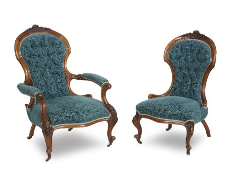 A pair of 19th century walnut ladies and gents chairsEach with foliate carved top rail, upholstered seat and back, raised on 