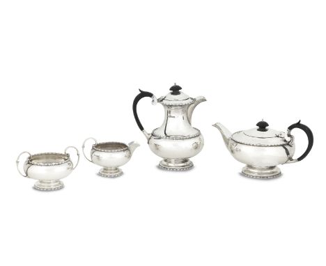 A four piece 20th century silver tea serviceby Walker &amp; Hall, Sheffield 1932 Comprising teapot, hot water pot, cream jug 