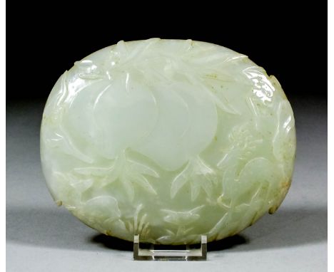 A Chinese jade oval plaque carved in relief with two peaches and two deer, 5.25ins (13.3cm) x 4.25ins (10.8cm) (Qing Dynasty 