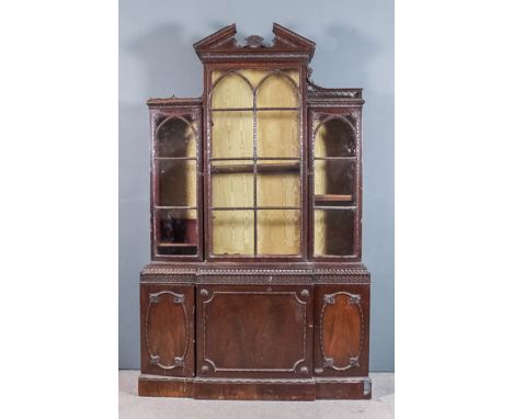 A 1920s mahogany breakfront bookcase of "Chippendale" design, the upper part with architectural moulded cornice carved with l