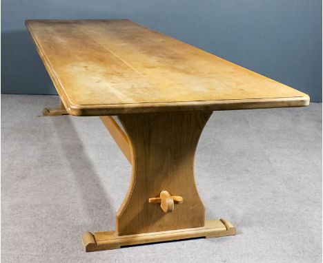 A light oak refectory table of "17th Century" design, with moulded edge to top and rounded corners, on shaped end supports an