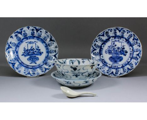 A pair of Chinese blue and white porcelain plates, the centres decorated with a vase of flowers, within floral pattern border