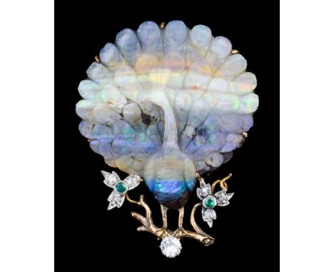 An early 20th Century gold coloured metal mount doublet opal set peacock pattern brooch, the stone finely carved as a peacock