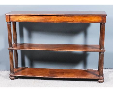 An early 19th Century mahogany three tier hall/console table, the top with rounded front corners, fitted one narrow frieze dr