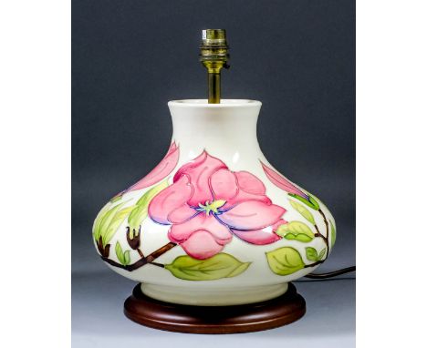 A Moorcroft pottery baluster-shaped lamp of depressed form, tube-lined and decorated in colours with "Magnolia" design, 12ins