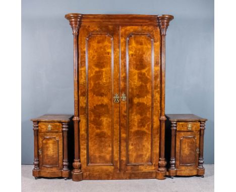 A Victorian burr walnut wardrobe with moulded cornice, enclosed by a pair of shaped panelled doors and with turned and fluted