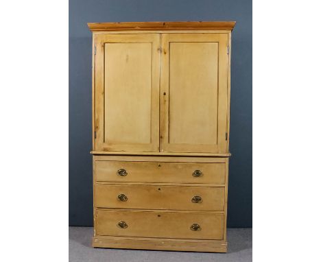 A Victorian gentleman's stripped pine wardrobe, the upper part with later moulded cornice, fitted three sliding trays enclose