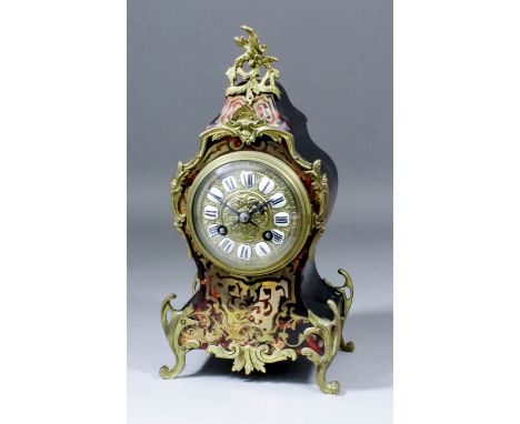 An early 20th Century French red tortoiseshell Boulle and ebonised cased mantel clock of "Louis XV" design, the 3.75ins diame