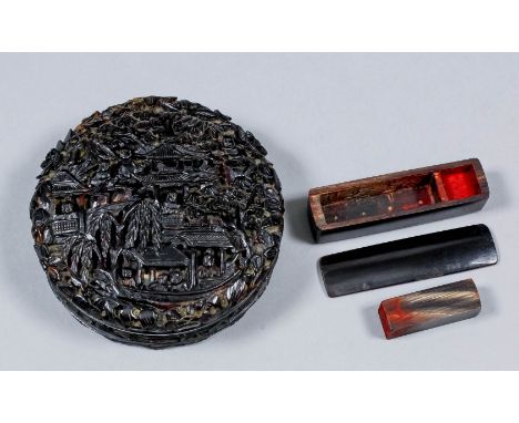 A Chinese circular tortoiseshell snuff box, the sides, top and base deeply carved with figures in pavilioned garden landscape